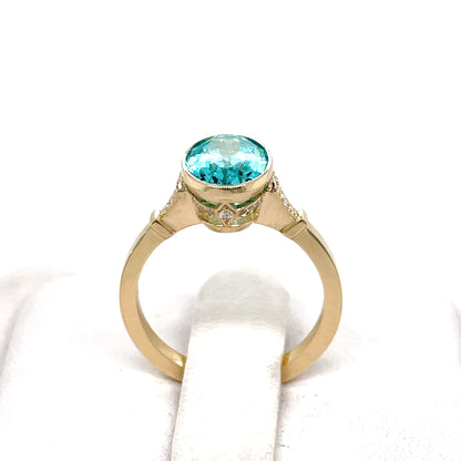 Gold ring with a Paraiba lab grown color stone